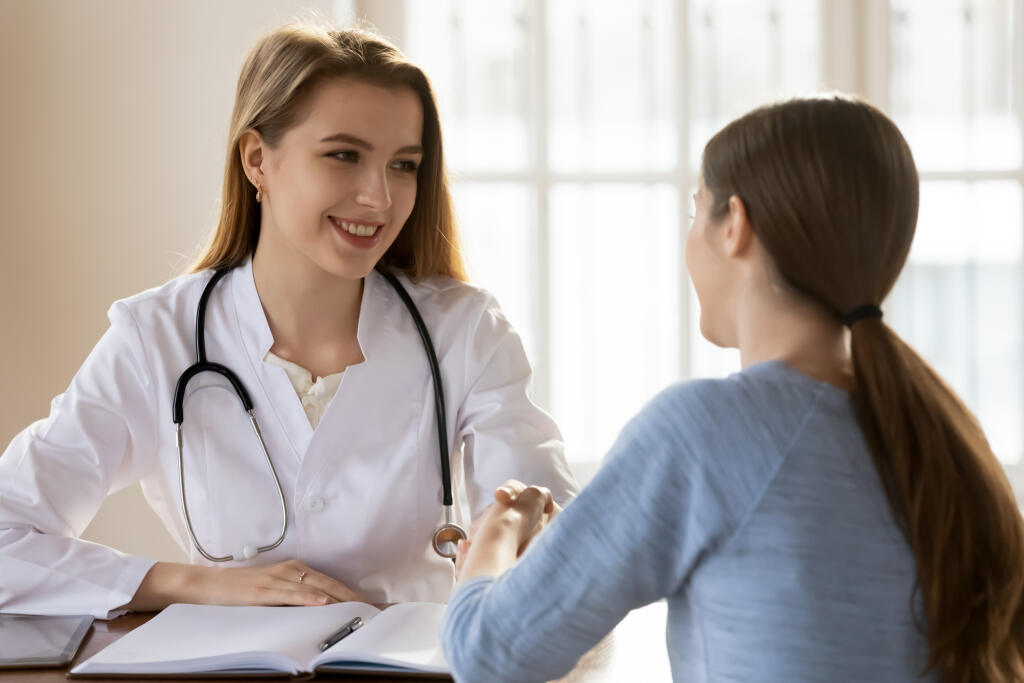 Smiling,Female,Doctor,Gp,Wearing,White,Uniform,With,Stethoscope,Shaking