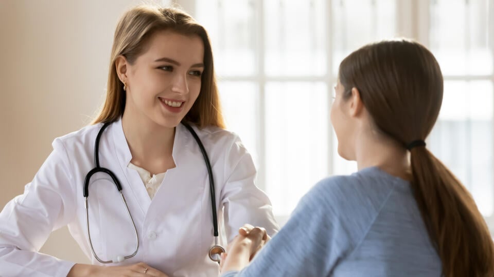 Smiling,Female,Doctor,Gp,Wearing,White,Uniform,With,Stethoscope,Shaking