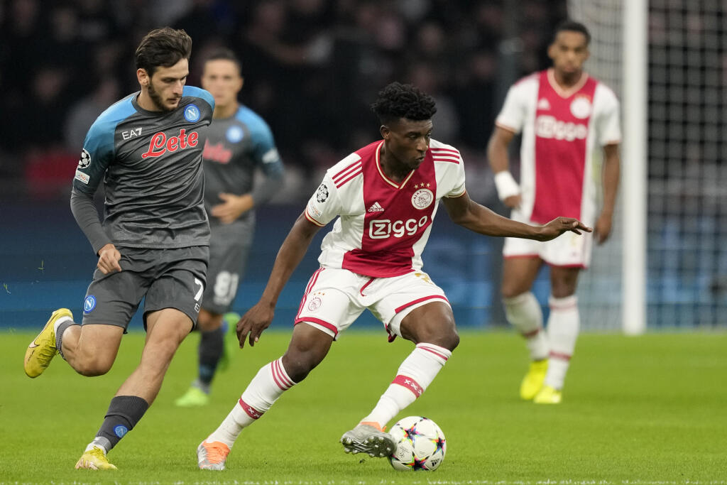 EBE 47 Amsterdam - Na snímke zľava gruzínsky útočník Neapola Chviča Kvaracchelija a hráč Ajaxu Mohammed Kudus v zápase A-skupiny 3. kola skupinovej fázy Ligy majstrov vo futbale Ajax Amsterdam - SSC Neapol v Amsterdame 4. októbra 2022. FOTO TASR/AP
Napoli's Khvicha Kvaratskhelia, left, challenges Ajax's Mohammed Kudus during the Champions League group A soccer match between Ajax and Napoli at the Johan Cruyff ArenA in Amsterdam, Netherlands, Tuesday, Oct. 4, 2022. (AP Photo/Peter Dejong)
