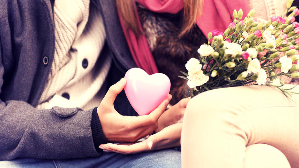 A,Midsection,Of,A,Romantic,Couple,Sitting,On,A,Bench