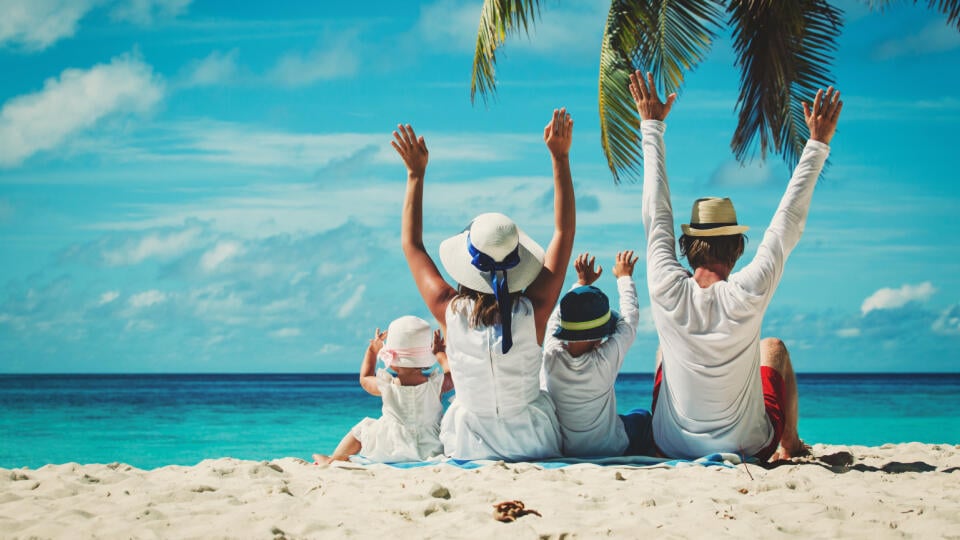 Happy,Family,With,Two,Kids,Hands,Up,On,The,Beach