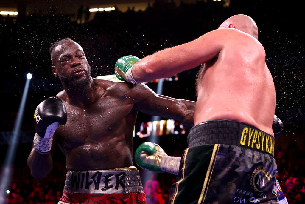 LAS VEGAS, NEVADA - OCTOBER 09: Tyson Fury (R) and Deontay Wilder exchange punches during their WBC heavyweight title fight at T-Mobile Arena on October 09, 2021 in Las Vegas, Nevada. (Photo by Al Bello/Getty Images)