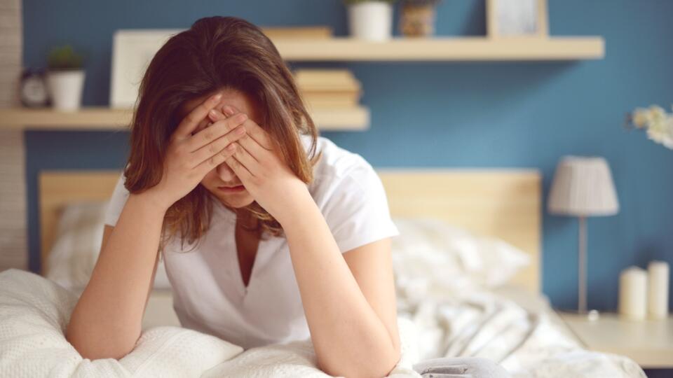 Unhappy girl in a bedroom