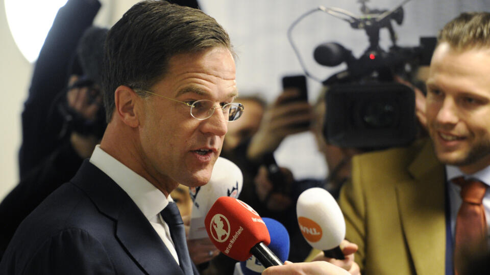 Dutch Prime Minister Mark Rutte answers journalists' questions after casting his vote for the Dutch general election in The Hague, Netherlands, Wednesday, March 15, 2017. (AP Photo/Patrick Post)