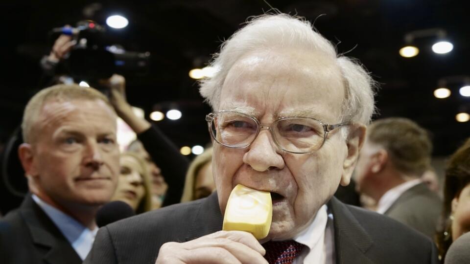 Berkshire Hathaway Chairman and CEO Warren Buffett eats an ice cream bar while touring the exhibition floor prior to the annual shareholders meeting on Saturday, May 3, 2014, in Omaha, Neb. More than 30,000 shareholders are expected to fill the CenturyLink Arena to hear Buffett and Berkshire Vice Chairman Charlie Munger discuss their business. (AP Photo/Nati Harnik)
