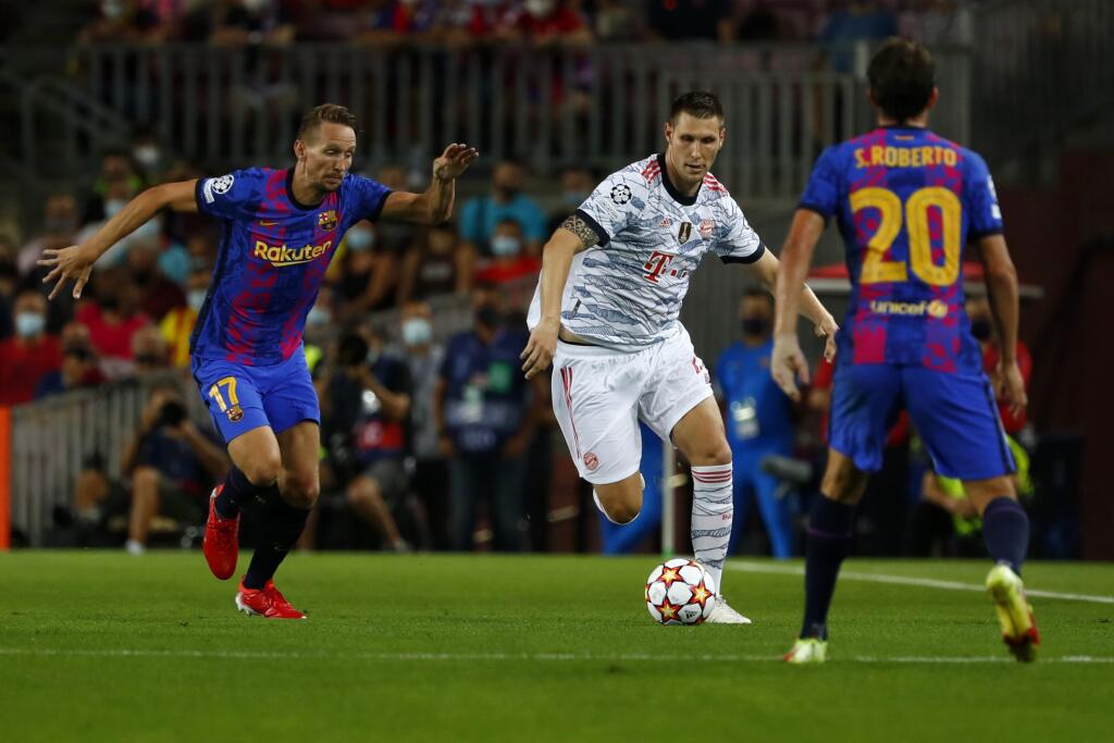 WA 37 Barcelona - Futbalista Bayernu Mníchov Niklas Süle (uprostred) a hráč Barcelony Luuk de Jong (vľavo) bojujú o loptu v zápase 1. kola E-skupiny Ligy majstrov FC Barcelona - Bayern Mníchov v Barcelone 14. septembra 2021. FOTO TASR/AP
Bayern's Niklas Suele fights for the ball against Barcelona's Luuk de Jong during a Champions League group E soccer match between F.C. Barcelona and Bayern at Camp Nou stadium in Barcelona, Spain, Tuesday, Sept. 14, 2021. (AP Photo/Joan Monfort)