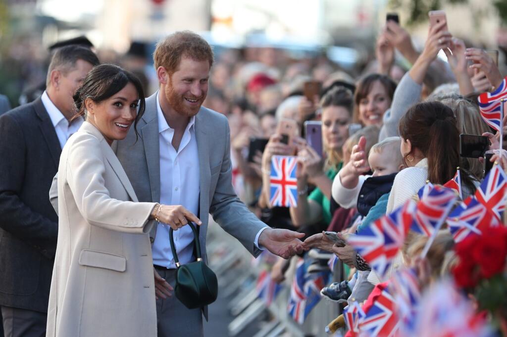 CHICHESTER, ENGLAND - OCTOBER 3: Meghan, Duchess of Sussex and Prince Harry, Duke of Sussex greet well-wishers as they arrive for an engagement at Edes House during an official visit to Sussex on October 3, 2018 in Chichester, England. The Duke and Duchess married on May 19th 2018 in Windsor and were conferred The Duke & Duchess of Sussex by The Queen. (Photo by Daniel Leal-Olivas - WPA Pool/Getty Images)