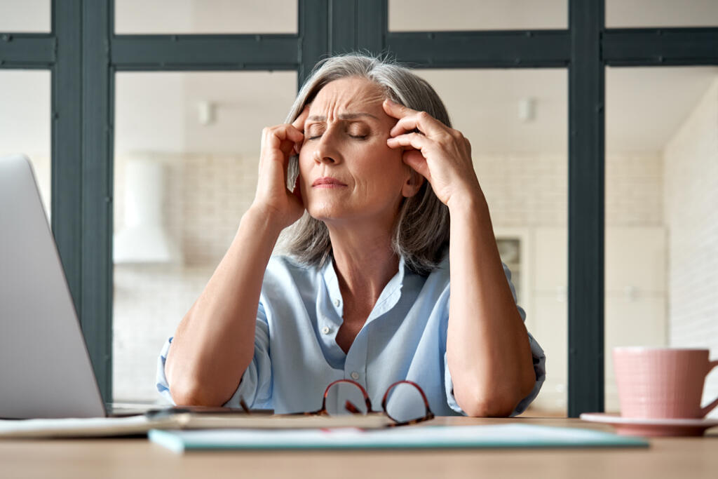 Tired,Stressed,Old,Mature,Business,Woman,Suffering,From,Headache,At