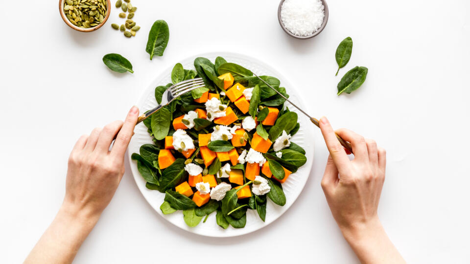 Eating,Salad.,Hands,Near,Plate,On,White,Background,Top-down