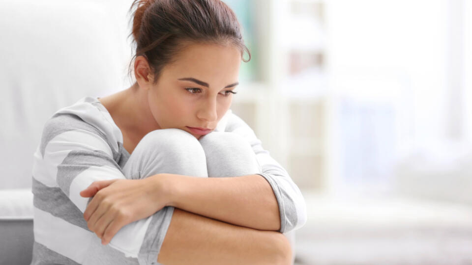 Depressed,Young,Woman,Sitting,On,Floor,At,Home