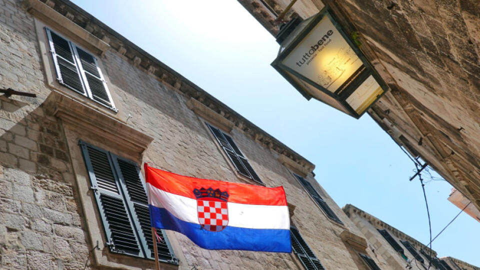 15 June 2019, Croatia, Dubrovnik: A Croatian flag is flying at a house of the Ulica Puca in the old town within the fortress wall. The approximately two kilometre long wall is between three and six metres wide along its entire length and is one of the city's landmarks. Photo: Soeren Stache/dpa-Zentralbild/ZB (Photo by Soeren Stache/picture alliance via Getty Images)