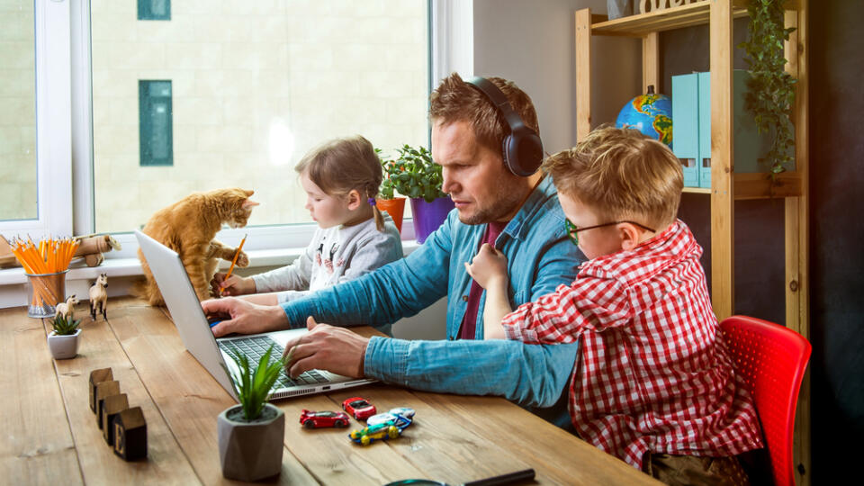 Work,From,Home.,Man,Works,On,Laptop,With,Children,Playing