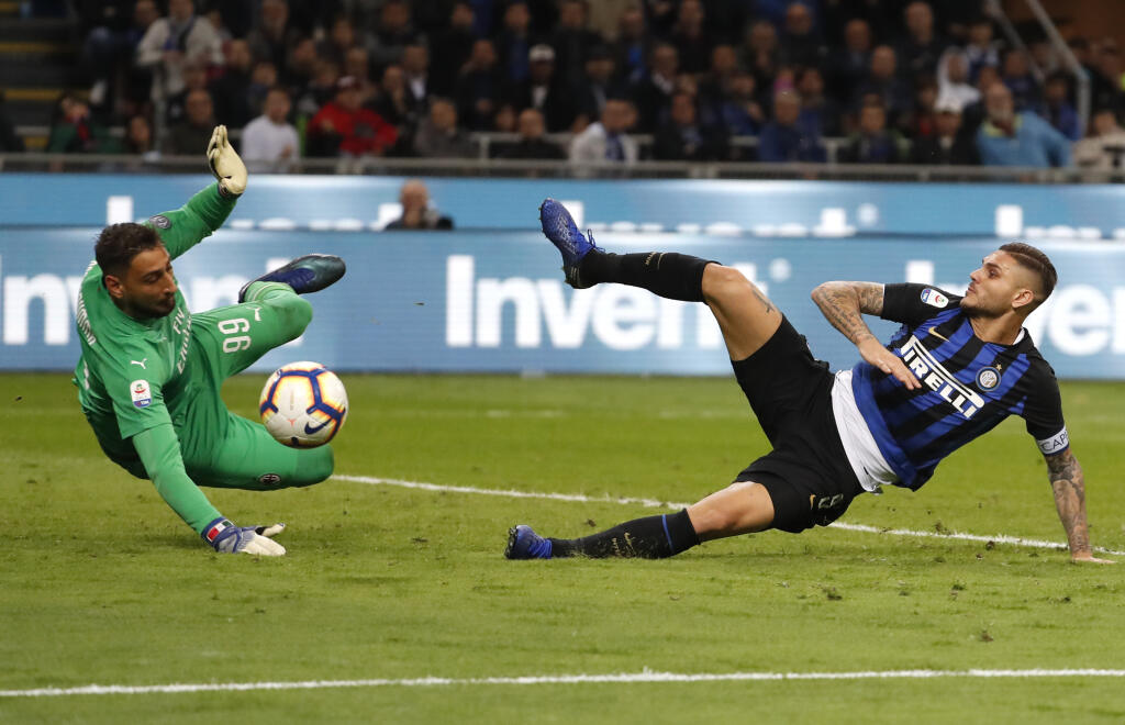 FILE - In this Sunday, Oct. 21, 2018 file photo, Inter Milan's Mauro Icardi, right, tries to score over AC Milan goalkeeper Gianluigi Donnarumma during the Serie A soccer match between Inter Milan and AC Milan at the San Siro Stadium, in Milan, Italy. Donnarumma has been a mainstay between the posts for Milan since making his debut in 2015 and has made more than 150 appearances for the club as well as also playing for the Italy national team. It is sometimes easy to forget how young he is. He t
