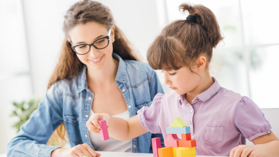 Young,Mother,And,Daughter,Playing,Together,At,Home,With,Colorful