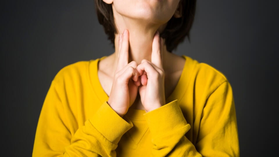 Young,Girl,Checks,The,Thyroid,Gland,With,Her,Hands,,Keeps