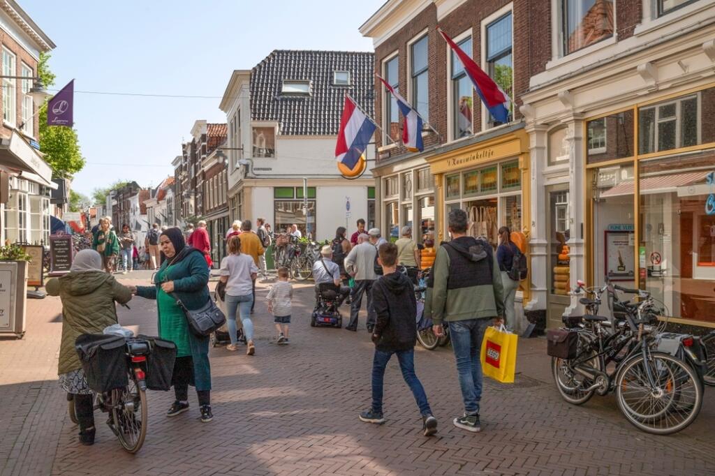 Gouda, Netherlands, May 2, 2024; People shopping in a pleasant shopping street in the center of Gouda.