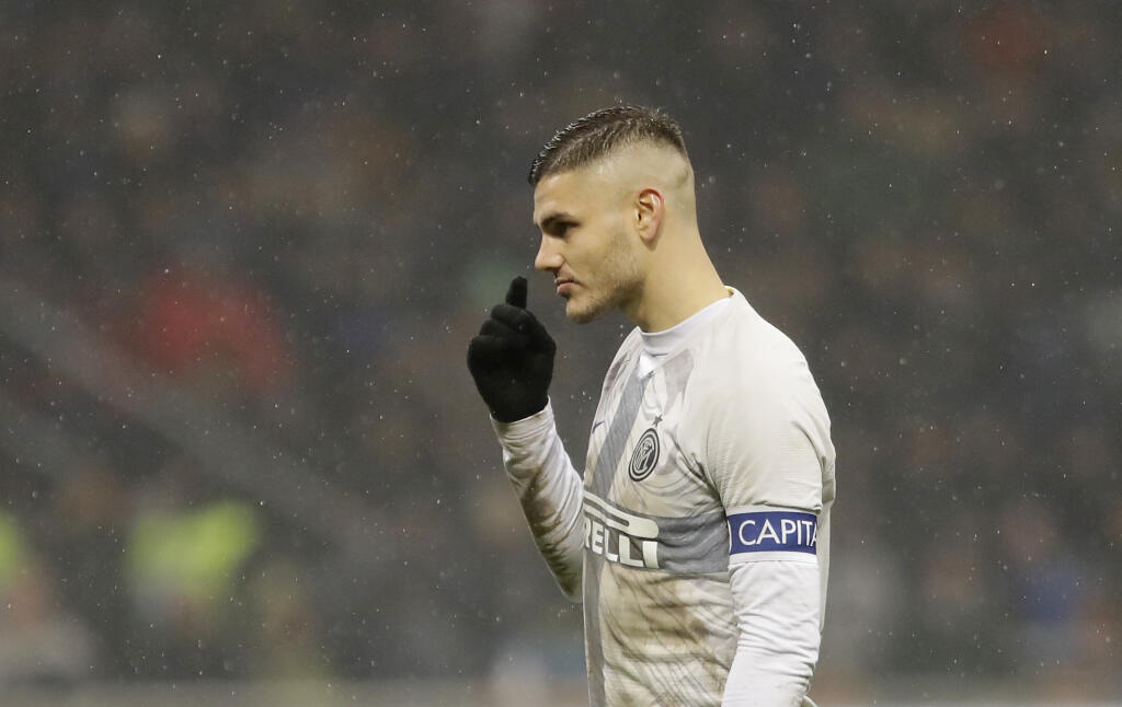 FILE - In this Jan. 31, 2019 file photo, Inter Milan's Mauro Icardi gestures during an Italian Cup quarterfinal soccer match between Inter Milan and Lazio at the San Siro stadium, in Milan, Italy. Two months ago, Mauro Icardi was one of Inter Milan's favored players, on Thursday, Feb. 14, 2019, he was training with just a handful of teammates at their training ground after a rapid fall from grace after Icardi and Inter have been in protracted talks over renewing his contract, which expires in 20