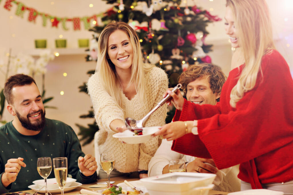 Group,Of,Family,And,Friends,Celebrating,Christmas,Dinner