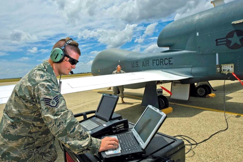 BN1E0G Staff Sgt. Ryan Conversi prepares an RQ-4 Global Hawk for launch using the vehicle test controller while reviewing technical ord