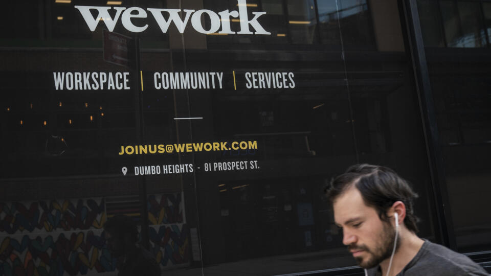NEW YORK, NY - SEPTEMBER 13: A man walks past a WeWork office facility in the DUMBO neighborhood in the Brooklyn borough of New York City on September 13, 2019. WeWork has chosen to list their IPO on the Nasdaq with a September 23 trading debut. The company is now considering a valuation of potentially less than $20 billion after being previously valued on the private market for as much as $47 billion. The company has also reduced CEO Adam Neumann's voting power after receiving sharp criticism