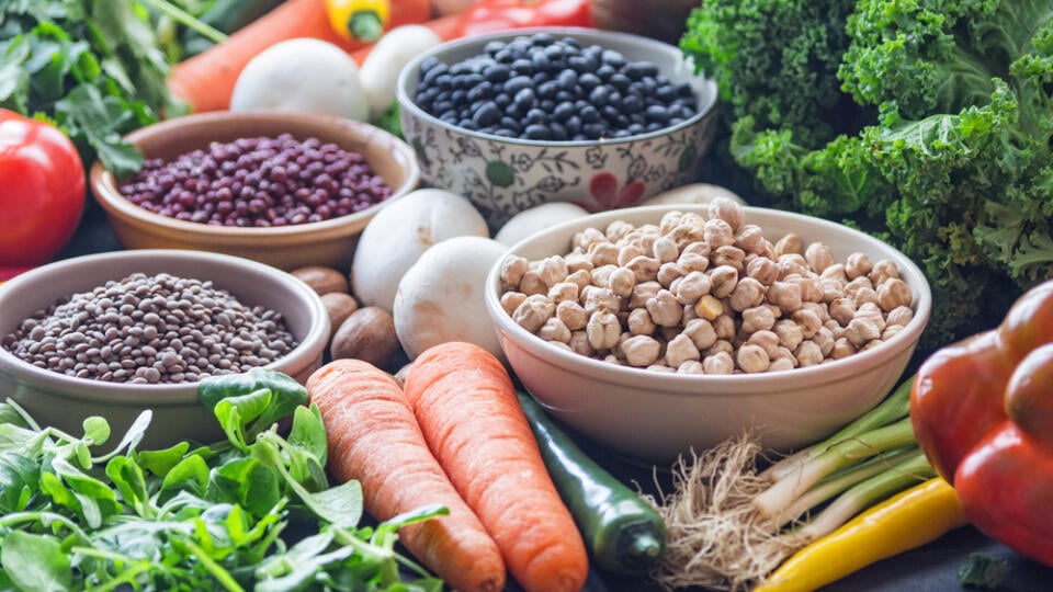 A,Table,With,Bowls,Of,Beans,And,Mixed,Vegetables