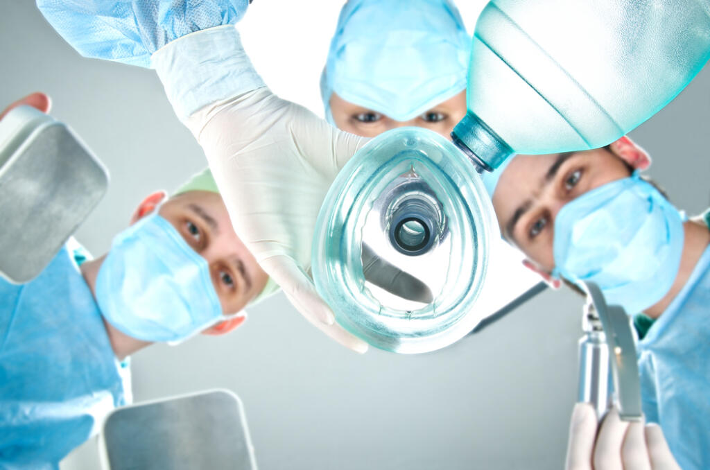 A,Team,Of,Three,Doctors,In,The,Operating,Room.,Doctor