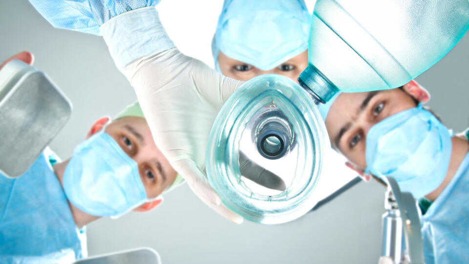 A,Team,Of,Three,Doctors,In,The,Operating,Room.,Doctor