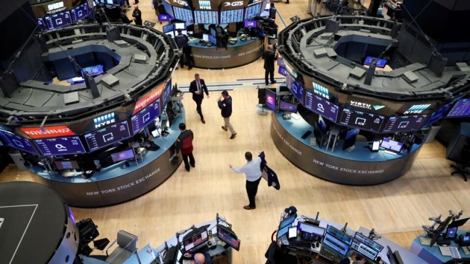 FILE PHOTO: Traders work on the floor of the NYSE in New York