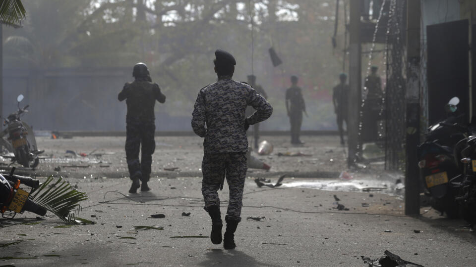 Sri Lankan security forces approach the site after a vehicle parked near St. Anthony's shrine exploded in Colombo, Sri Lanka, Monday, April 22, 2019. Easter Sunday bombings that ripped through churches and luxury hotels killed more than 200 people.(AP Photo/Eranga Jayawardena)