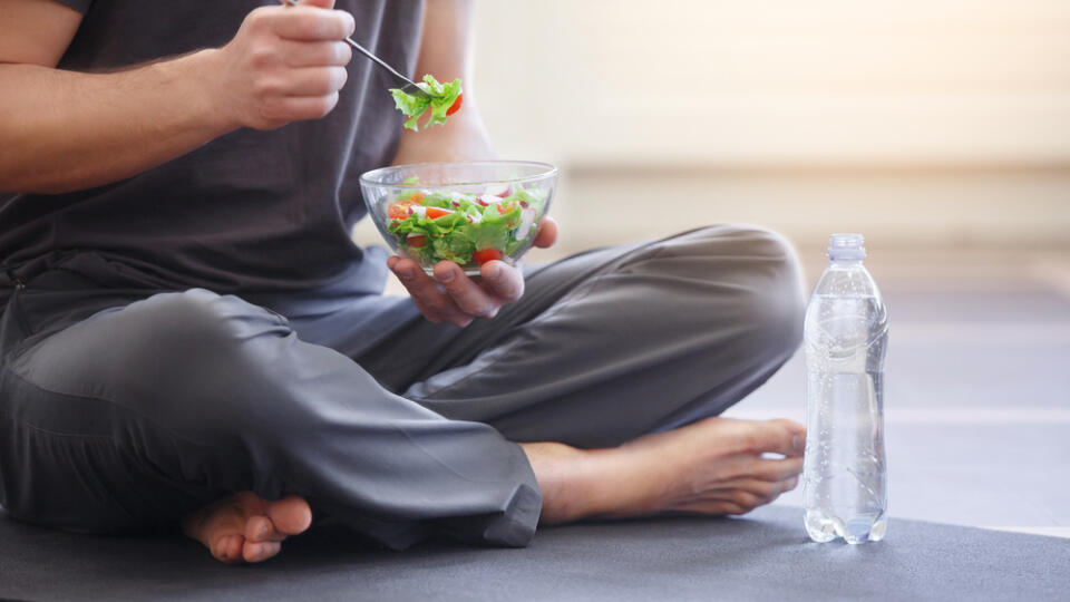 Yoga,Men,With,A,Bowl,Of,Vegetable,Salad,,A,Bottle