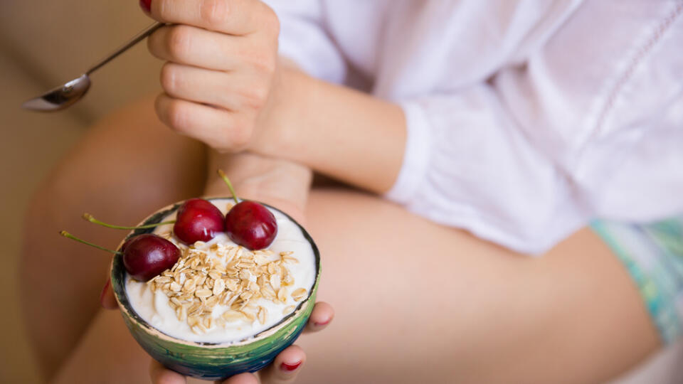 Closeup,Of,Woman's,Hands,Holding,A,Cup,With,Organic,Yogurt