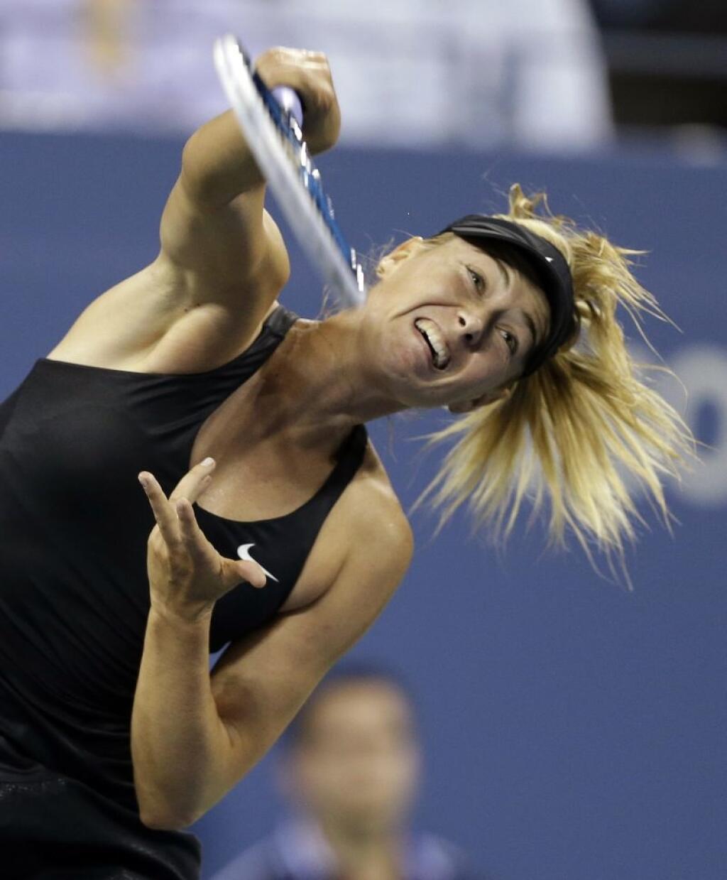 Maria Sharapova, of Russia, serves to Maria Kirilenko, of Russia, during the opening round of the U.S. Open tennis tournament Monday, Aug. 25, 2014, in New York. (AP Photo/Darron Cummings)