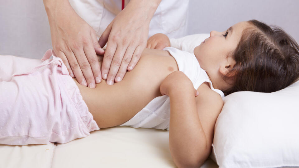 Pediatrician,Doing,Abdominal,Examination,With,Hands