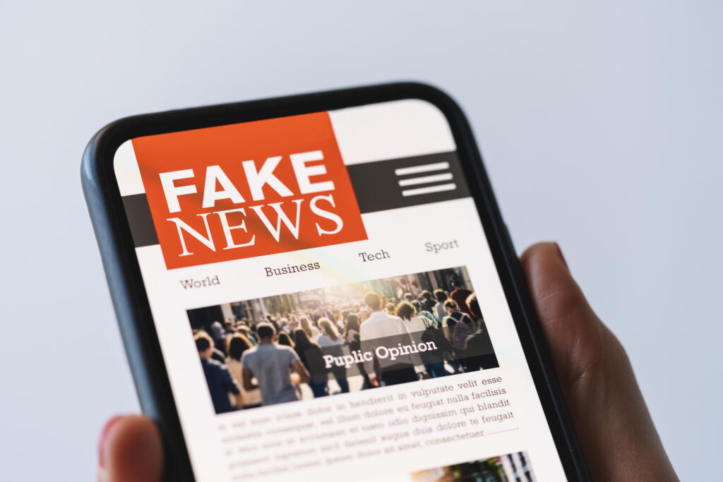 Online,Fake,News,On,A,Mobile,Phone.,Close,Up,Of