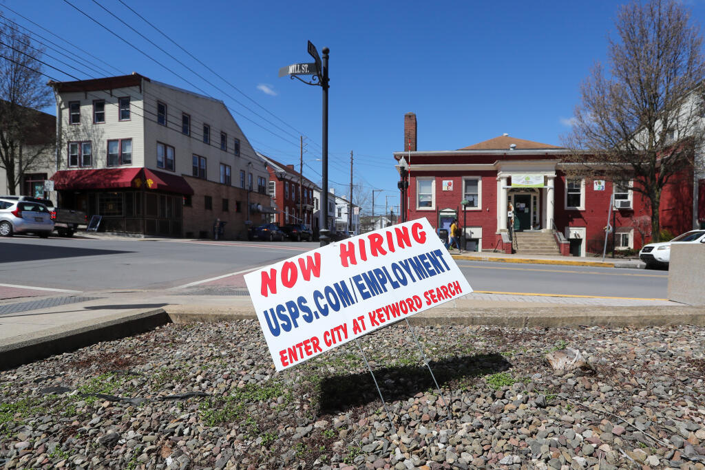 A now hiring sign at the Post Office in Danville