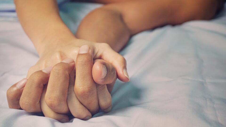 Man,And,Woman,Hands,Having,Sex,On,A,Bed.,Make
