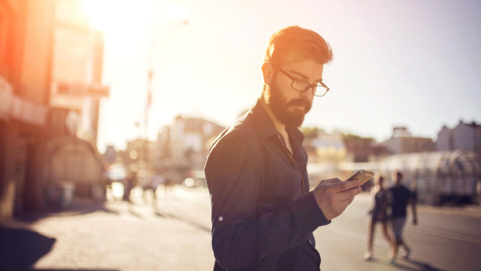 Handsome man sending text message