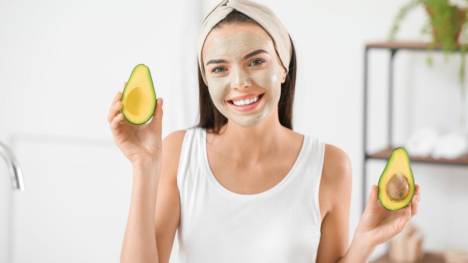 Beautiful,Young,Woman,With,Facial,Mask,And,Avocado,In,Bathroom