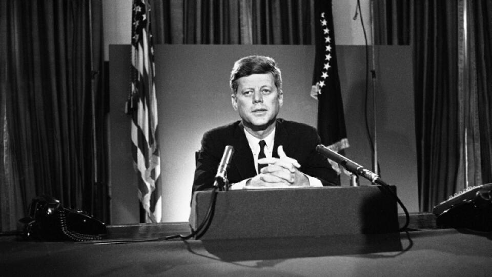 FILE - In this July 26, 1963 file photo, U.S. President John F. Kennedy sits behind microphones at his desk in Washington after finishing his radio-television broadcast to the nation on the nuclear test ban agreement initialed by negotiators in Moscow. (AP Photo/John Rous)