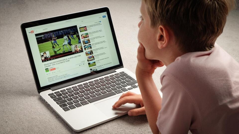 A Child watching Youtube videos on a laptop computer