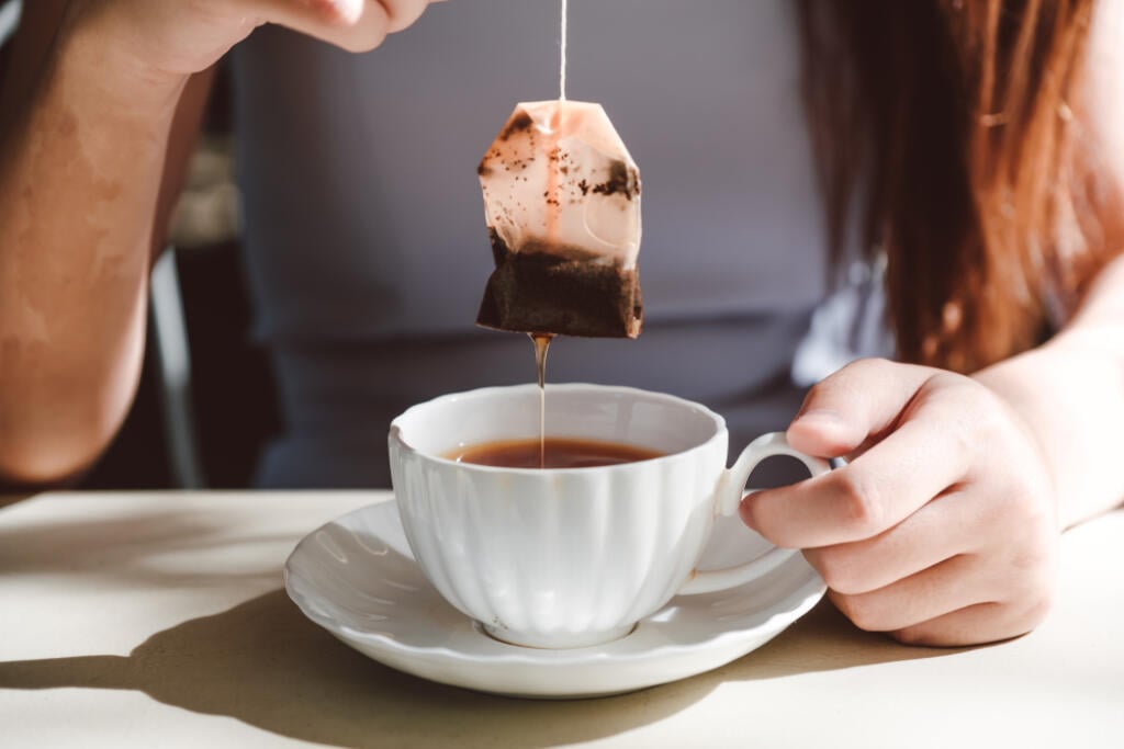Woman,With,Grey,Dress,Is,Soaking,Tea,Bag,On,Vintage