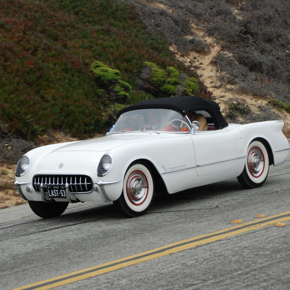 The last 1953 Corvette built; there were 300 Corvettes built that year, the first year the Corvette was available. Photographed at the Pebble Beach Tour d'Elegance on Pacific Coast Highway. White sports car convertible on scenic drive.
