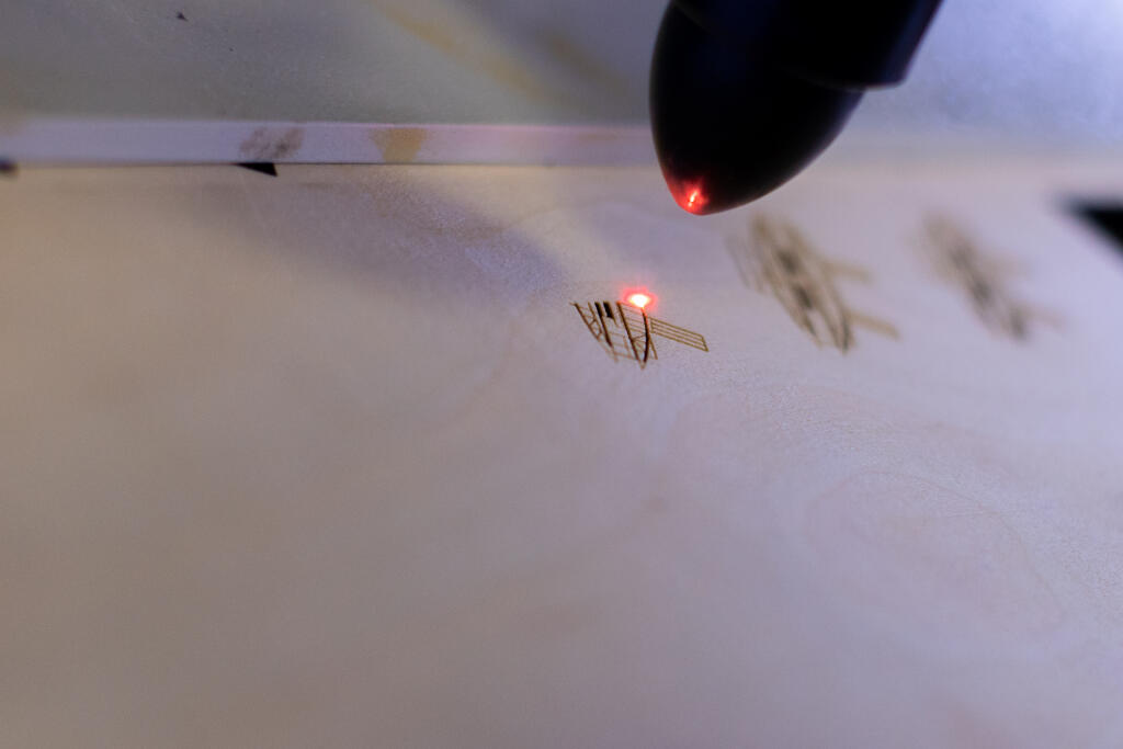 Rodí sa brošňa na leteckej preglejke - laser vypaľuje motív.