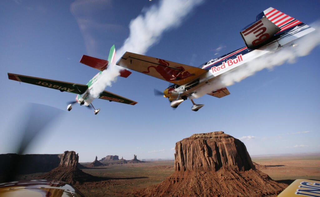 In this image provided by Sports&News on Thursday, May 10, 2007, U.S. racers Michael Goulian of Dragon Racing and Kirby Chambliss of Team Red Bull, from left, perform during the reconnaissance flight for the 3rd leg of the Red Bull Air Race World Series in Monument Valley, Utah, Wednesday, May 9, 2007. The 3rd leg takes place on Saturday. (AP Photo/Balazs Gardi, Sports&News, HO) ** NO SALES EDITORIAL USE ONLY **