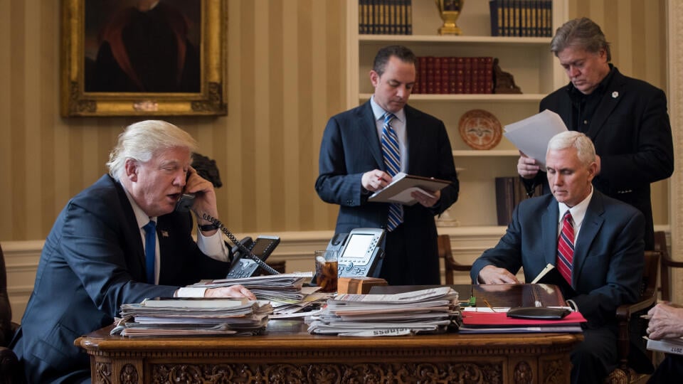 WASHINGTON, DC - JANUARY 28: President Donald Trump speaks on the phone with Russian President Vladimir Putin in the Oval Office of the White House, January 28, 2017 in Washington, DC. Also pictured, from left, White House Chief of Staff Reince Priebus, Vice President Mike Pence, and White House Chief Strategist Steve Bannon. On Saturday, President Trump is making several phone calls with world leaders from Japan, Germany, Russia, France and Australia. (Photo by Drew Angerer/Getty Images)