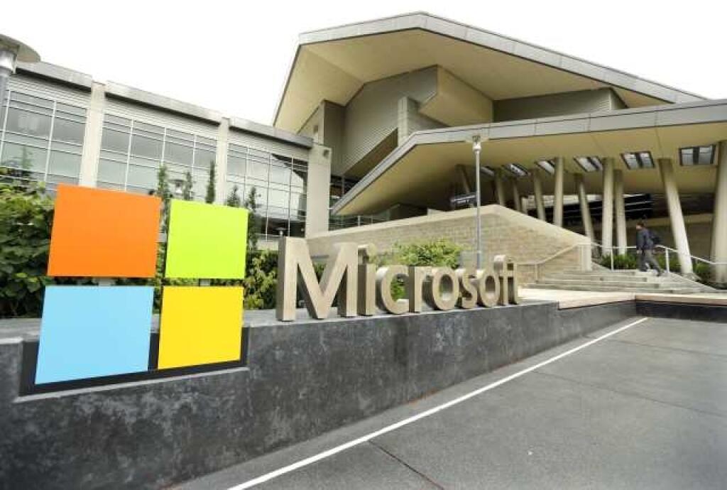 FILE - This July 3, 2014 file photo shows Microsoft Corp. signage outside the Microsoft Visitor Center in Redmond, Wash. Microsoft on Thursday, March 26, 2015 said that it will push its U.S. suppliers to give their employees paid time off — but that only applies for the staffers that do work for Microsoft. (AP Photo Ted S. Warren, File)