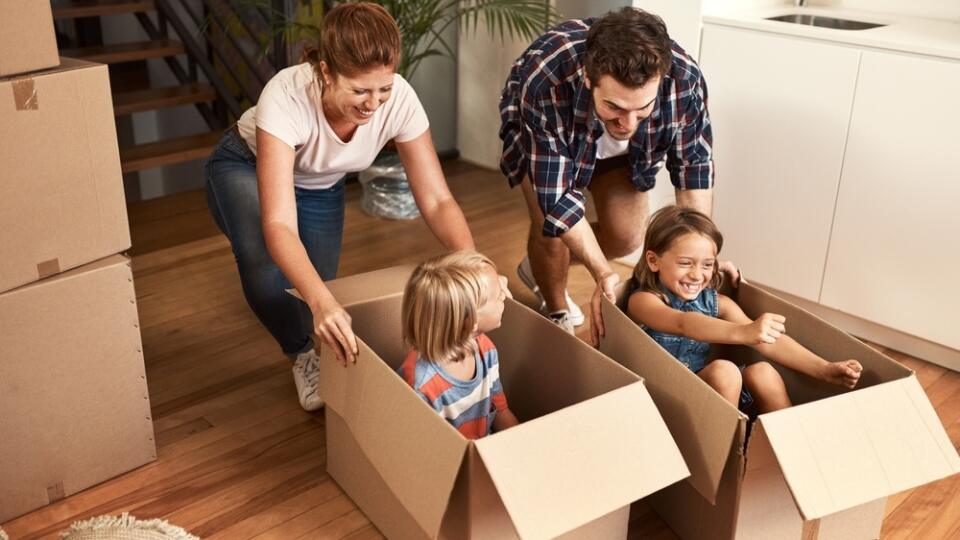 New,House,,Happy,Family,And,Children,Or,Playing,In,Boxes