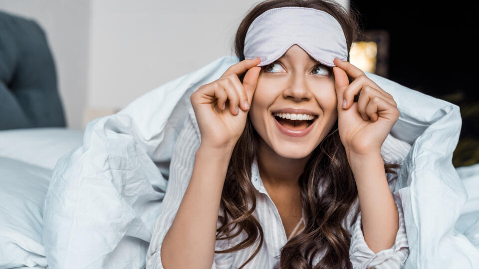 Beautiful,Excited,Girl,In,Sleeping,Eye,Mask,Lying,In,Bed