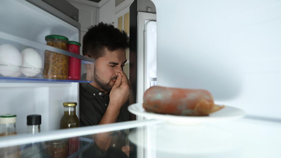 Young,Man,Feeling,Bad,Smell,Of,Spoiled,Sausage,In,Refrigerator,