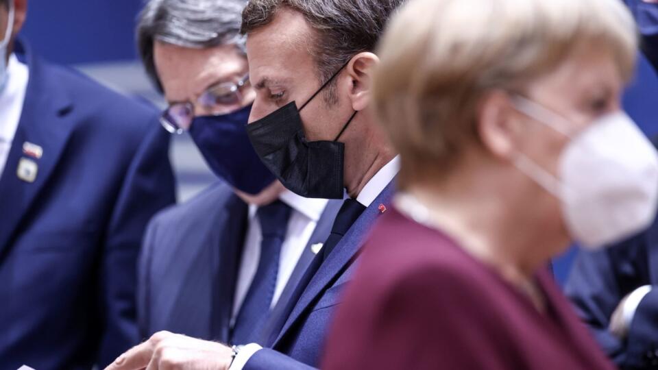 French President Emmanuel Macron, center, speaks with Cypriot President Nicos Anastasiades, left, during a round table meeting at an EU summit in Brussels, Friday, Oct. 16, 2020. European Union leaders meet for the second day of an EU summit, amid the worsening coronavirus pandemic, to discuss topics on foreign policy issues.